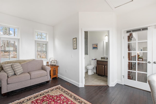 living area with baseboards and dark wood finished floors