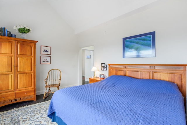 bedroom with high vaulted ceiling, baseboards, and dark wood finished floors