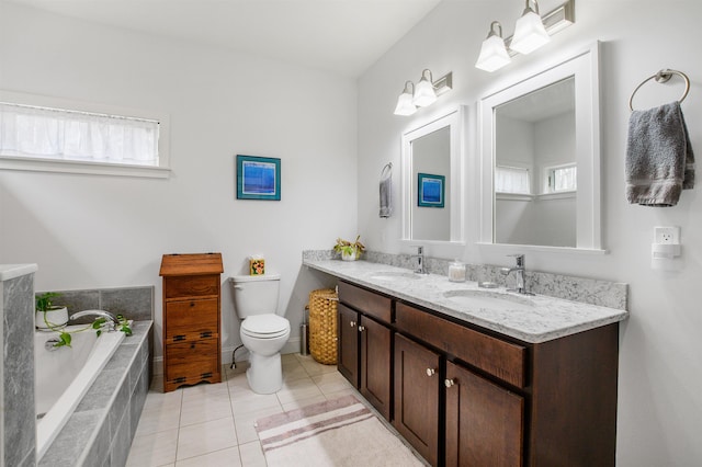 full bathroom featuring a sink, tile patterned flooring, double vanity, and a bath