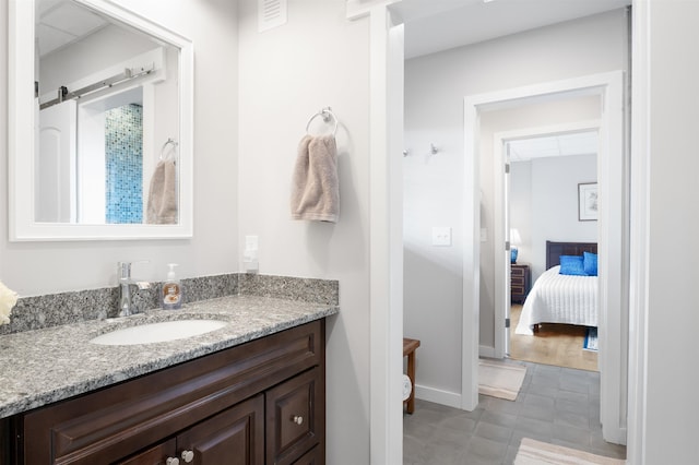 bathroom featuring tile patterned floors, visible vents, baseboards, and vanity