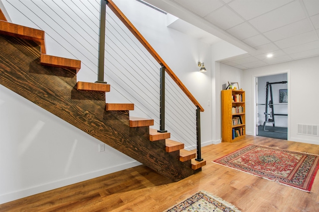 stairs featuring recessed lighting, baseboards, visible vents, and wood finished floors