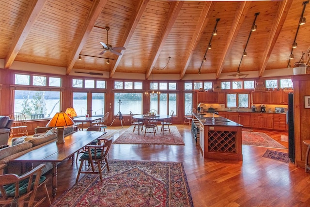 dining space with wooden ceiling, ceiling fan, track lighting, and wood finished floors