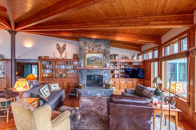 living room featuring a stone fireplace, wood ceiling, wood finished floors, and vaulted ceiling with beams