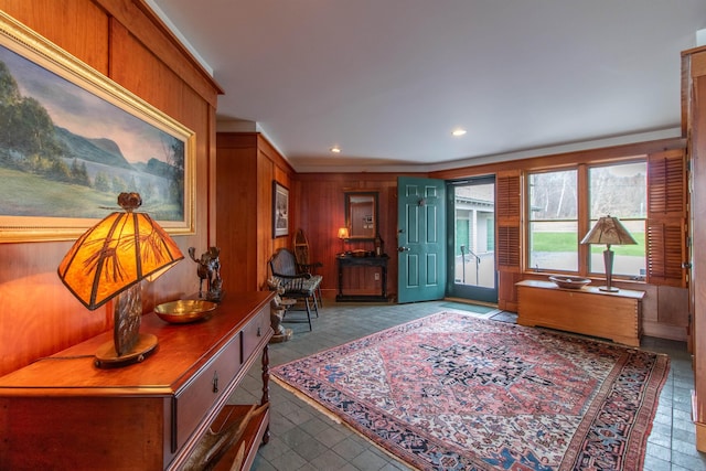 entrance foyer with wooden walls, recessed lighting, and light tile patterned floors