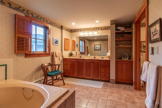 bathroom with double vanity, a bath, tile patterned flooring, a sink, and wallpapered walls