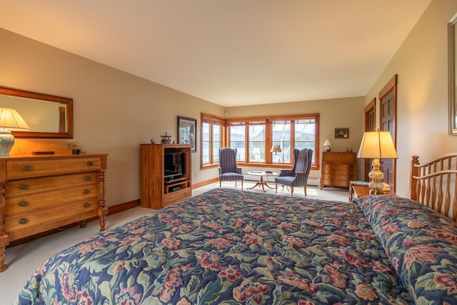 carpeted bedroom with baseboards and a baseboard radiator