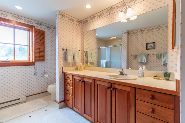 full bathroom with vanity, wallpapered walls, a stall shower, and a baseboard heating unit
