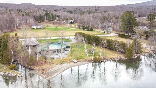 drone / aerial view with a water view and a forest view