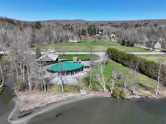 aerial view featuring a forest view and a water view