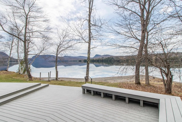 wooden terrace with a water and mountain view