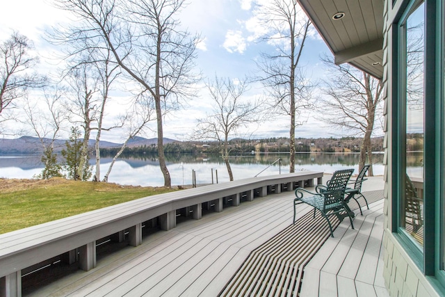 deck with a water and mountain view