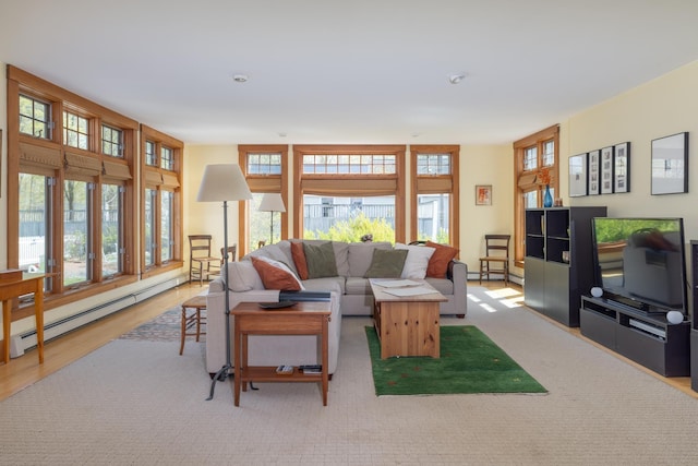 living area with wood finished floors and a baseboard radiator