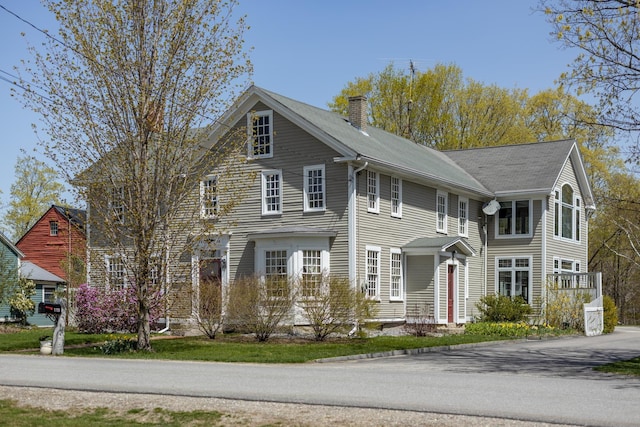 view of front of home featuring a chimney