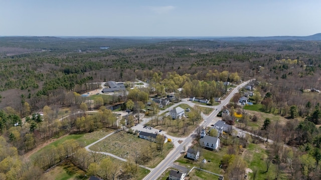 drone / aerial view with a wooded view