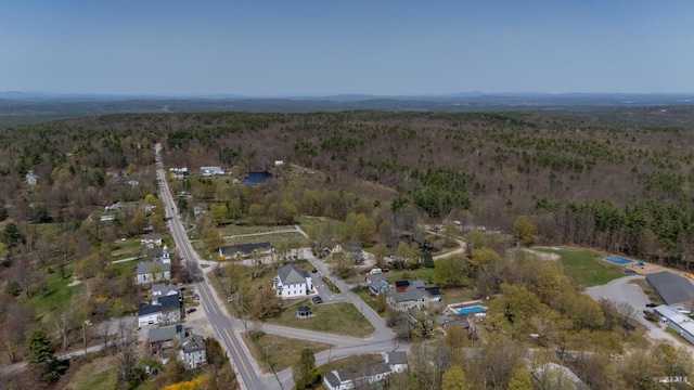 drone / aerial view featuring a view of trees