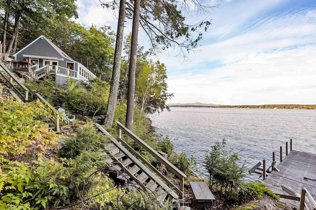 view of dock featuring stairs and a water view