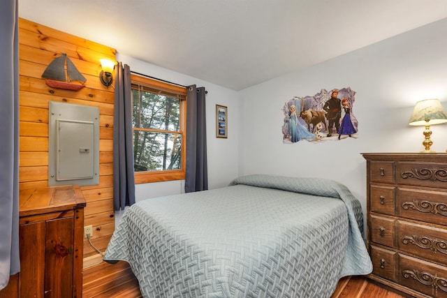 bedroom with wood finished floors and electric panel
