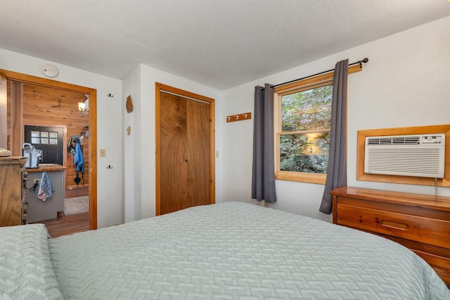 bedroom featuring a closet and a wall mounted air conditioner
