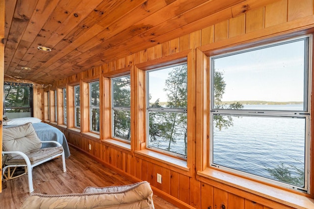 sunroom / solarium with wooden walls and wood finished floors