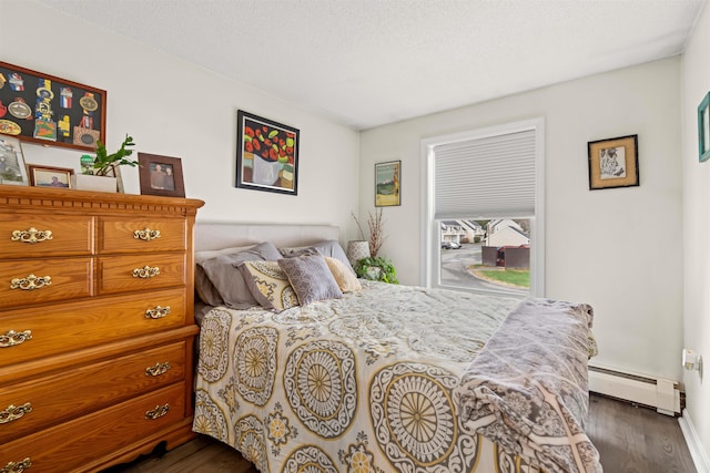 bedroom featuring baseboards, a baseboard radiator, and dark wood finished floors