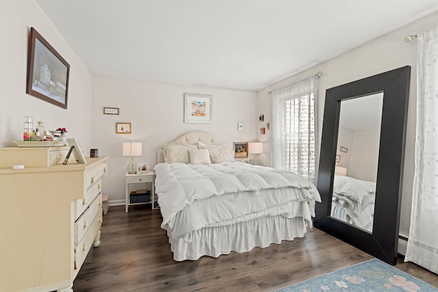 bedroom with baseboards and dark wood-style flooring