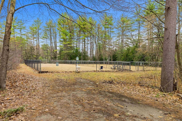 view of yard with fence and a forest view