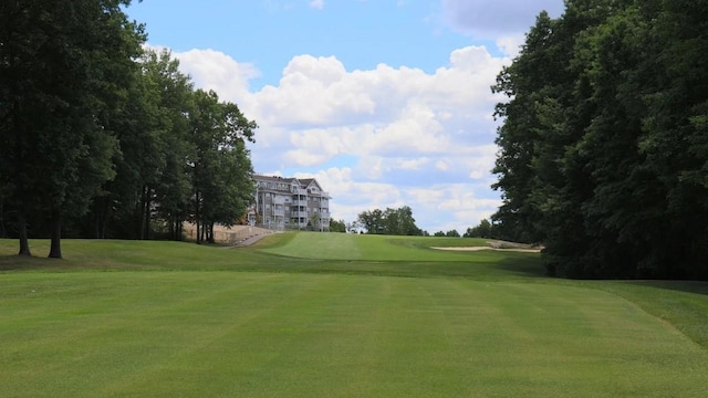 view of community with a lawn and view of golf course