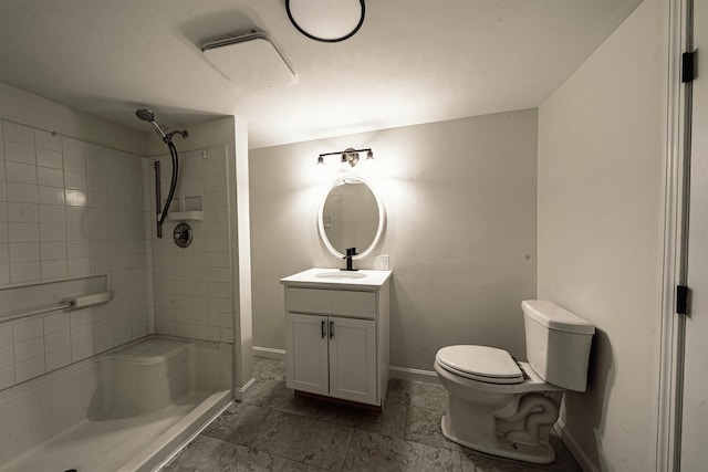 bathroom featuring baseboards, a stall shower, toilet, and vanity