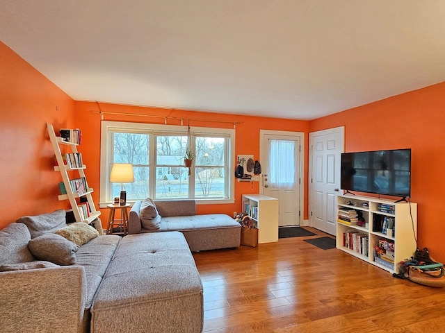 living area featuring wood finished floors and a healthy amount of sunlight