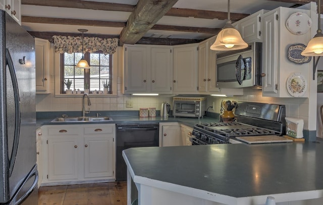 kitchen featuring white cabinets, dark countertops, a sink, beamed ceiling, and black appliances