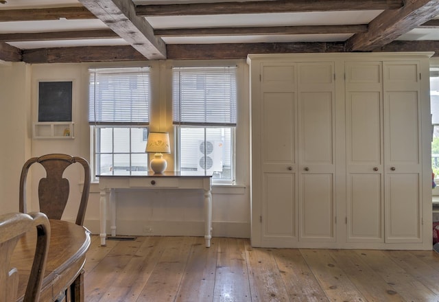 interior space featuring beam ceiling and light wood-type flooring