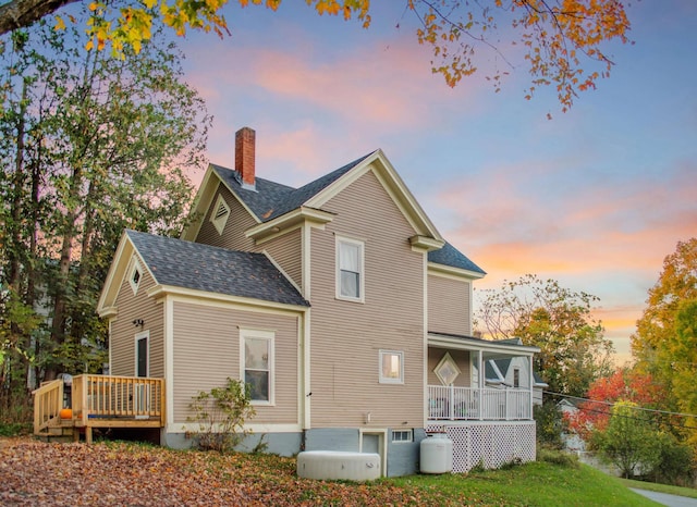 19 Orchard St, Newport City, VT 05855 - rear view of property with a wooden deck, covered porch, fence, a chimney, and a shingled roof