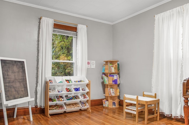 19 Orchard St, Newport City, VT 05855 - playroom with crown molding, baseboards, and hardwood / wood-style flooring