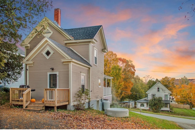 19 Orchard St, Newport City, VT 05855 - traditional home with roof with shingles, a chimney, and a deck