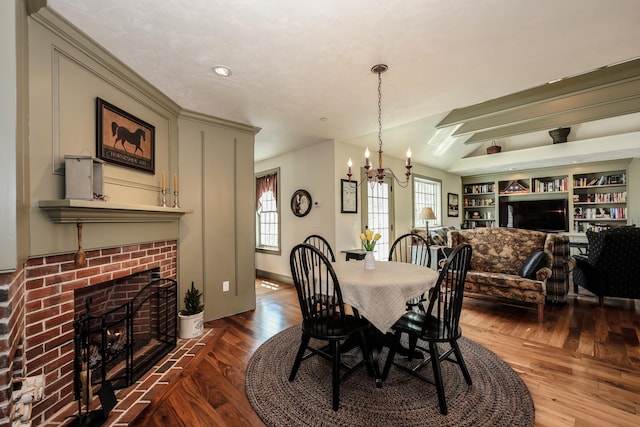 31 Shetland Rd, Chester, NH 03036 - dining area with a chandelier, dark wood-style floors, and a fireplace
