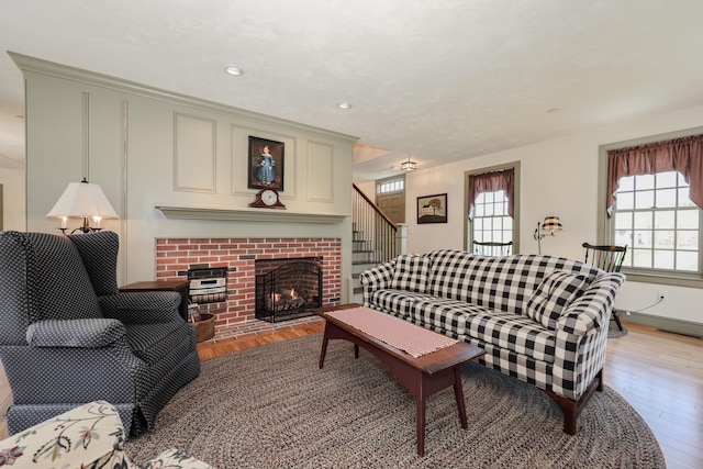 31 Shetland Rd, Chester, NH 03036 - living room with light wood-style floors, stairway, a brick fireplace, and recessed lighting