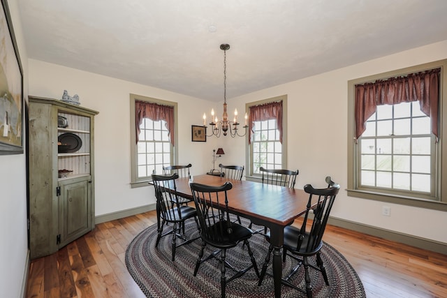 31 Shetland Rd, Chester, NH 03036 - dining room featuring a notable chandelier, a wealth of natural light, and light wood-style floors