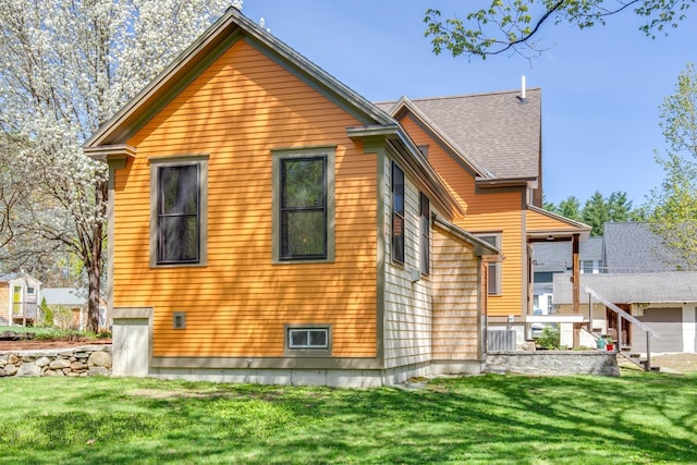 back of house with a lawn