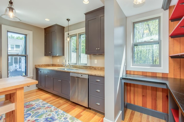 kitchen featuring stainless steel dishwasher, open shelves, a wealth of natural light, and light wood-type flooring
