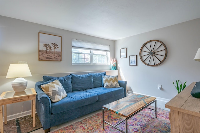carpeted living area featuring baseboards