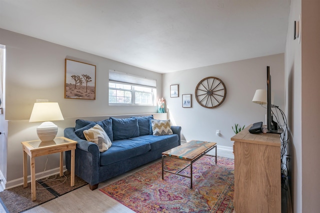 living area with baseboards and light wood-style flooring