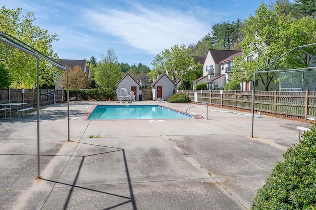 view of pool with fence, a shed, a patio area, and a fenced in pool