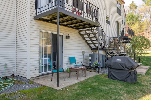 view of patio / terrace featuring central AC, a balcony, stairway, and area for grilling