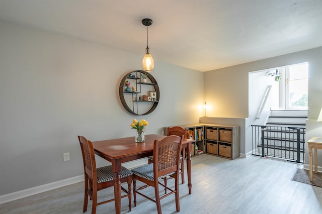 dining room with baseboards and wood finished floors