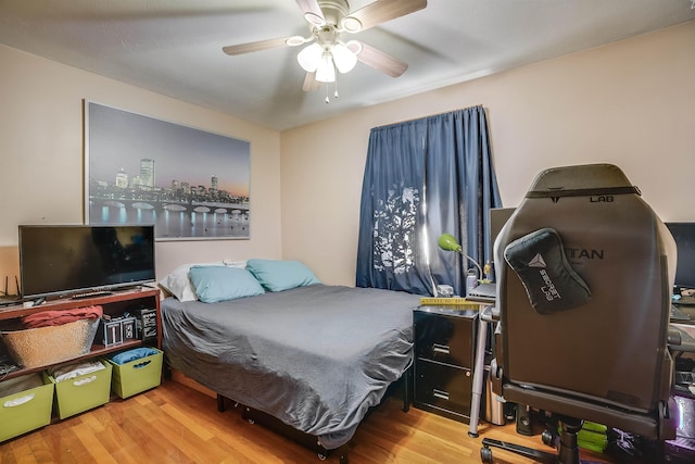 bedroom with a ceiling fan and wood finished floors