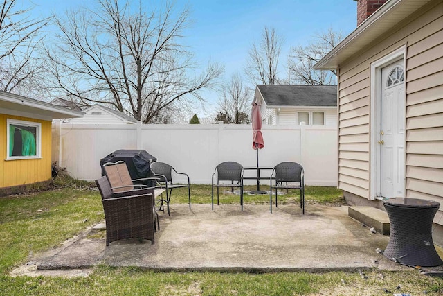 view of patio with a fenced backyard and a grill
