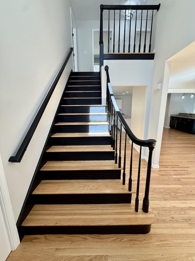 stairs featuring baseboards and wood finished floors