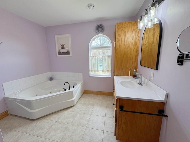 full bathroom featuring a jetted tub, baseboards, tile patterned flooring, and vanity