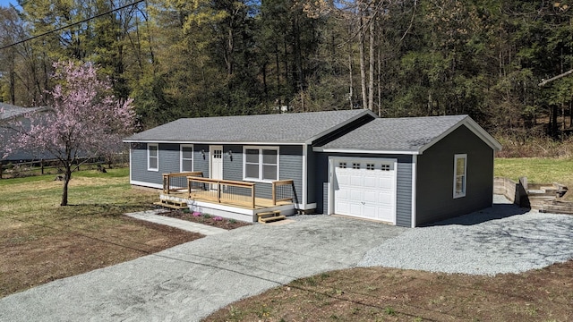 single story home featuring a front yard, an attached garage, driveway, and roof with shingles