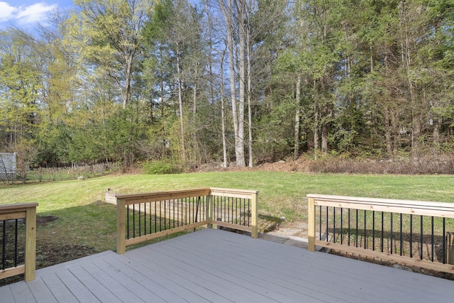 wooden terrace featuring a yard